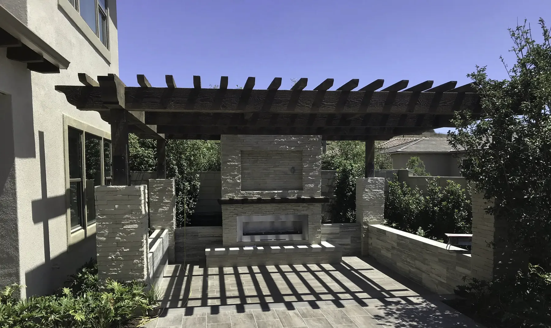 Photo. Attached patio covers — solid patio cover with a fireplace, wide